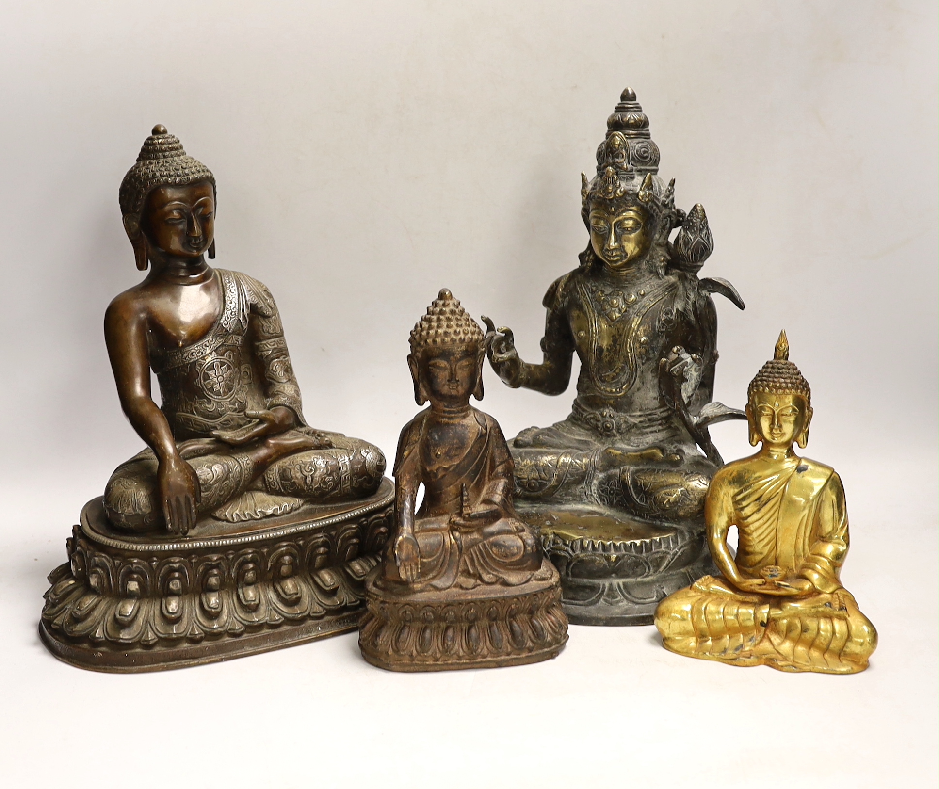 Four Thai and far-eastern bronze figures of the Buddha, tallest 28cm